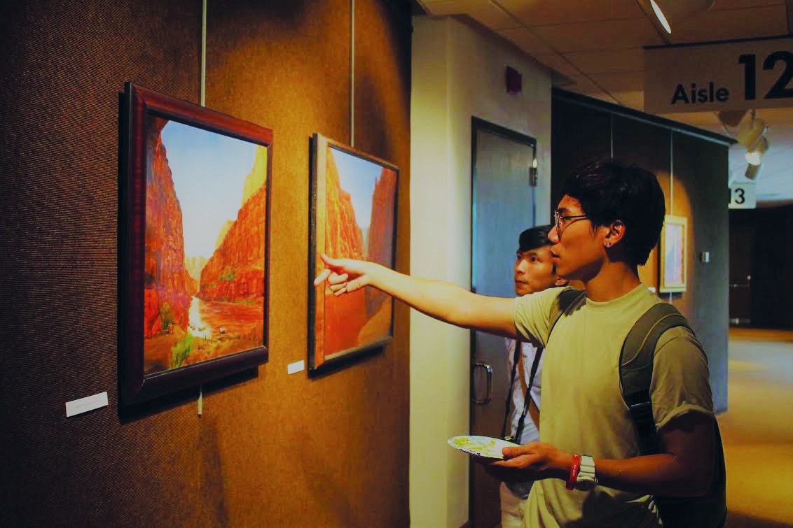 Nam+Nguyen+%28%E2%80%9818%29+admires+Homstad%E2%80%99s+work+displayed+in+the+CFL.