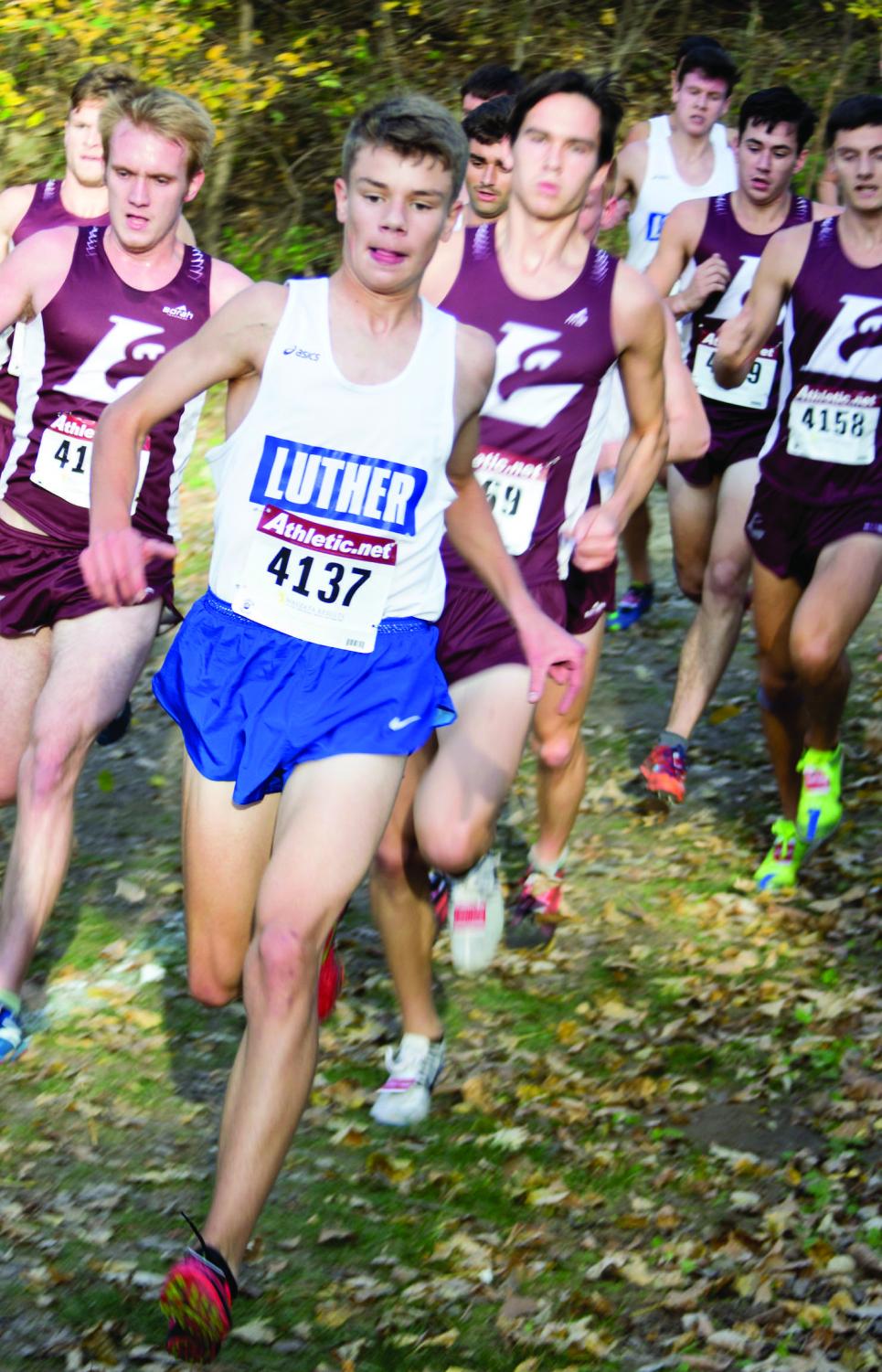 Maximilian Walker (21) cruises downhill, a pack of La Crosse runners in pursuit during the dual.