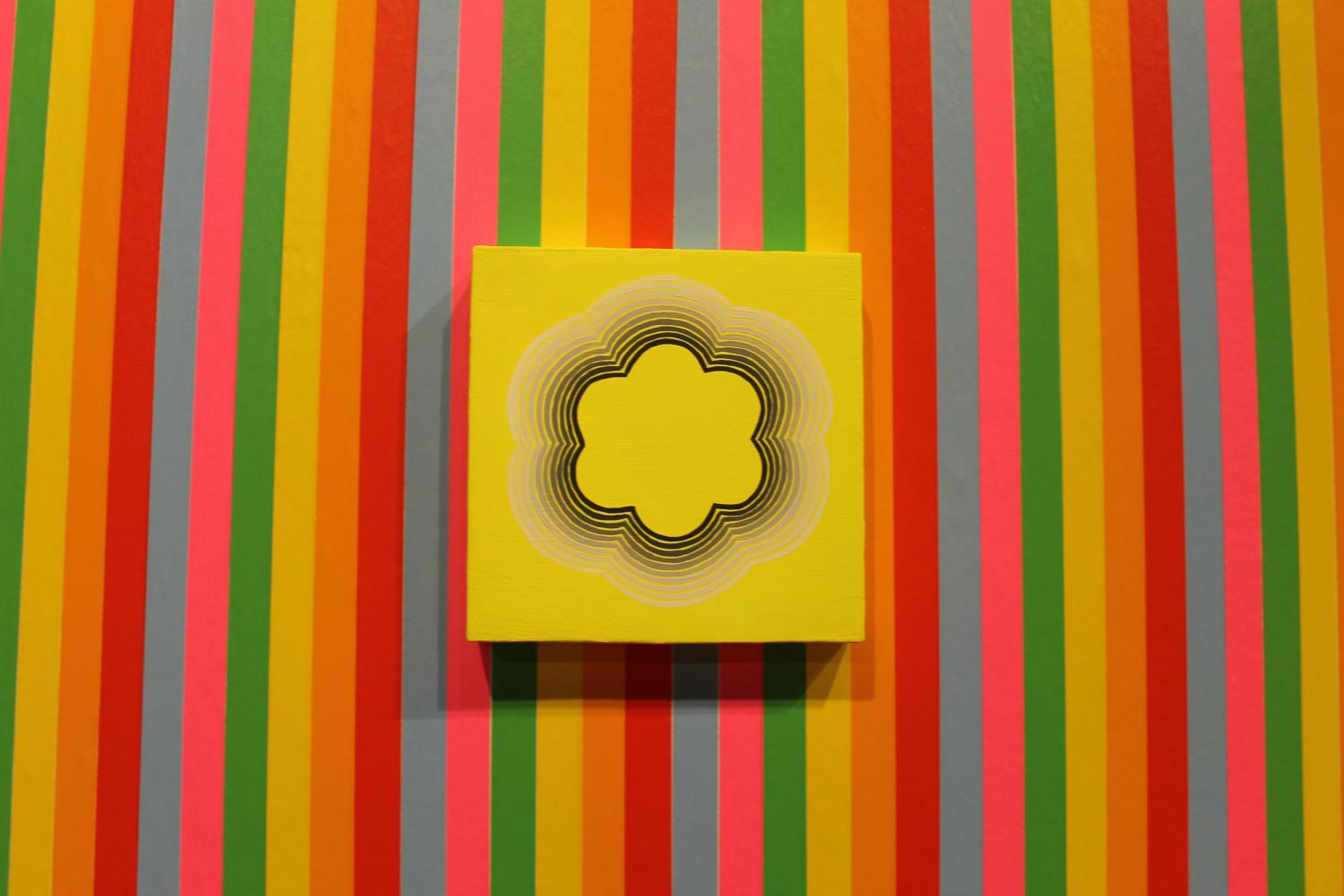 James Jankowiak’s art exhibit “Prismatic Vernacular” features a striped wall made with colorful tape.
