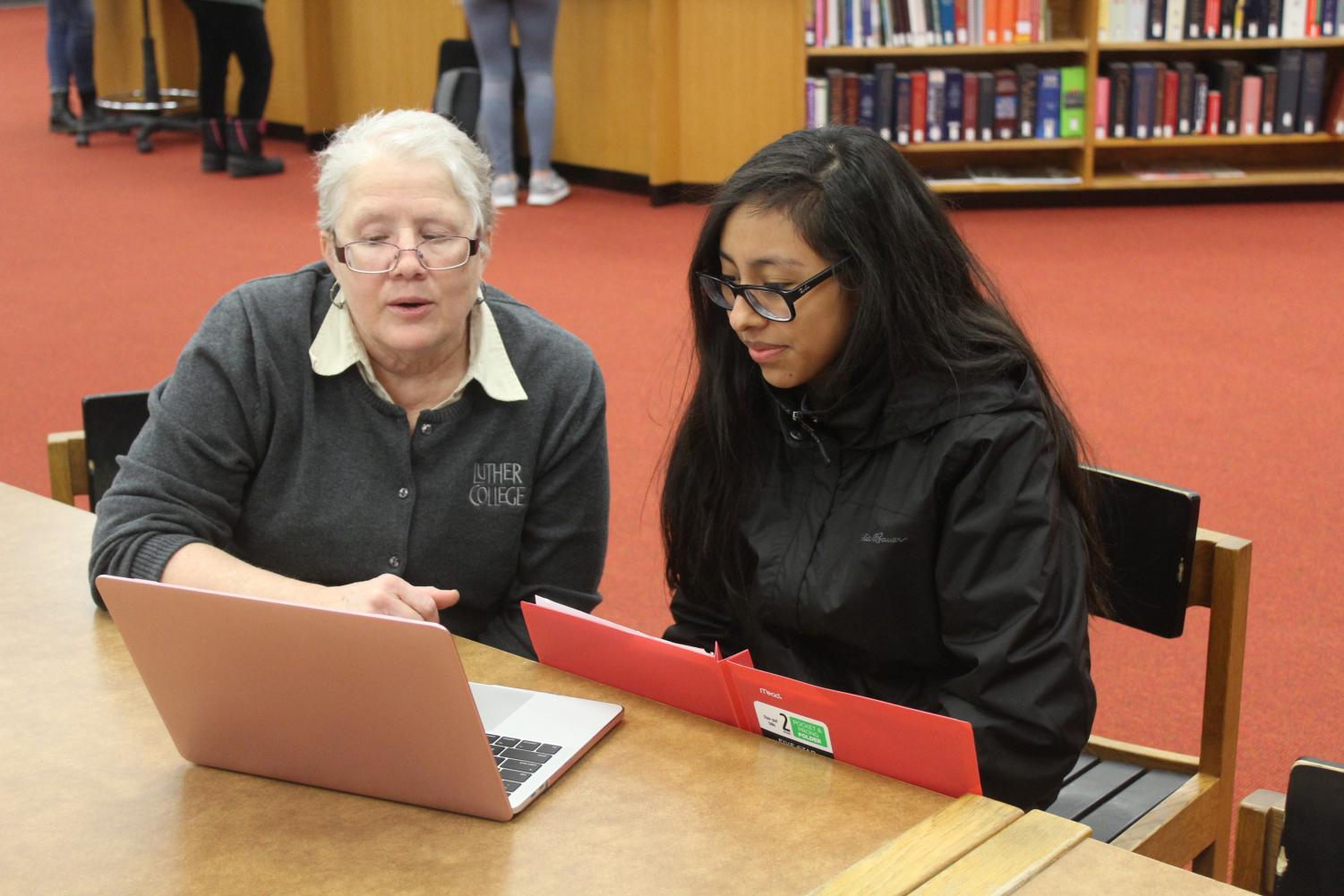 Professor of History Jackie Wilkie helps Lorelayn Coto ('21) with research for Paideia.