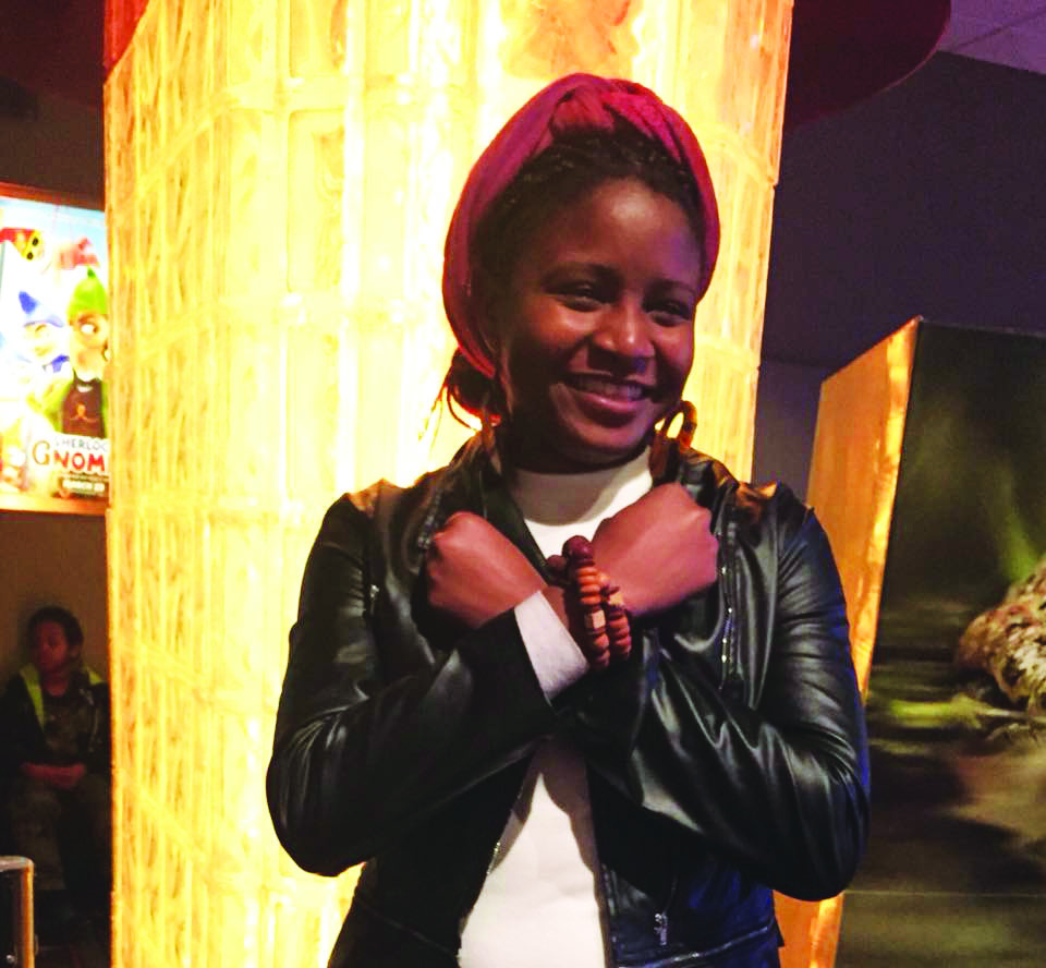 Tiwonge Chirwa ('19) demonstrates the Wakandan greeting as depicted in the movie between characters T'Challa and Shuri.