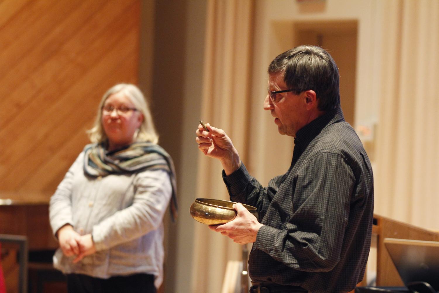 Gallery Coordinator David Kaam holds a brass bowl with 80 bullet casings. Some of the casings contained pieces of paper with the names of victims of the Sandy Hook shooting in 2012.
