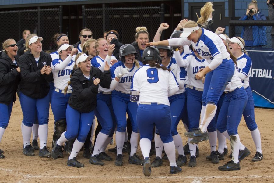 Softball celebrates after their win. 