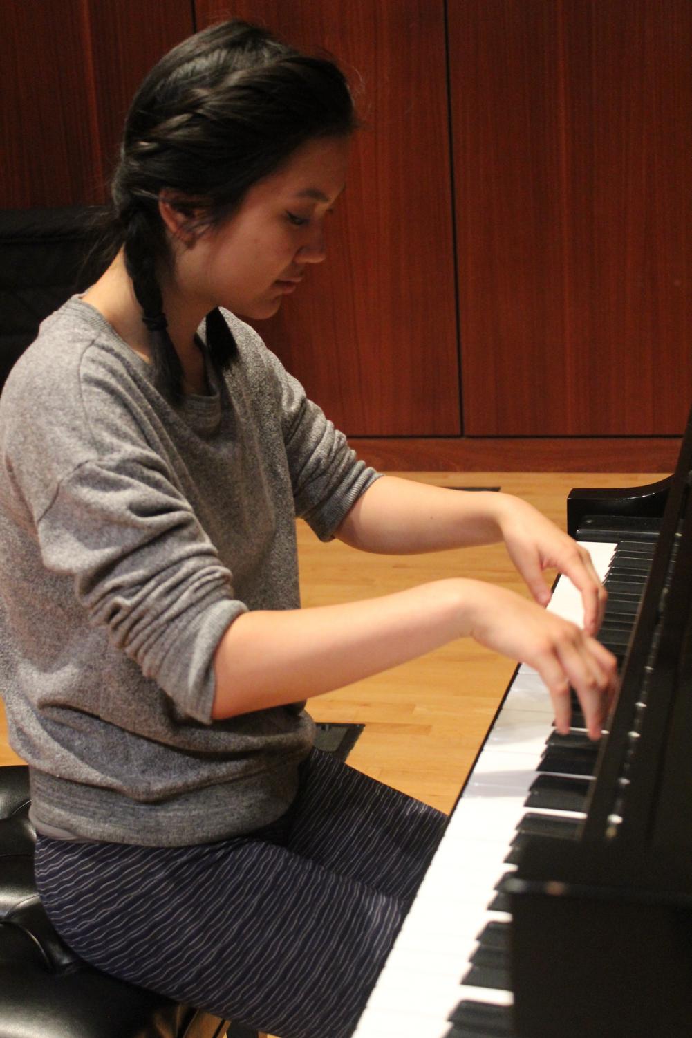 Shana Liu ('21) practices for her performance with the Des Moines Community Orchestra.