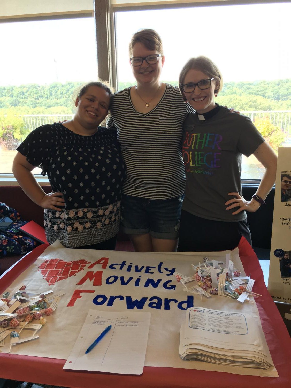 Alex Atal ('19), Jana Mueller ('19), Pastor Annie Edison-Albright advertising Actively Moving Forward at the Fall Activities Fair
