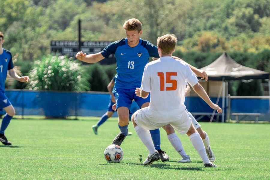 Luke VonEschen (19) dribbles past opponent in Luther vs. Carroll University game.