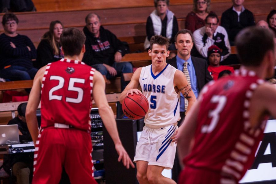 Gage Thompson (21) dribbles the ball against Bethany Lutheran on Nov. 17. Thompson led all scorers in this game with 22 points.