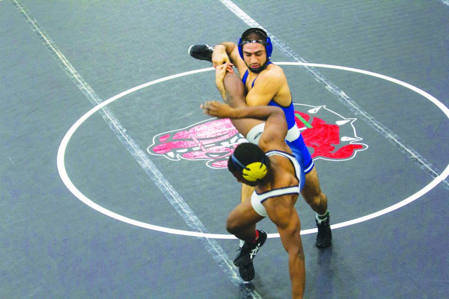 Michael Suarez (‘19) completes a leg attack leading to a takedown at the Gator Boots Duals on Dec. 15.