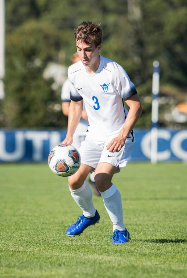 Steven Johnson (21) competes for the ball. 