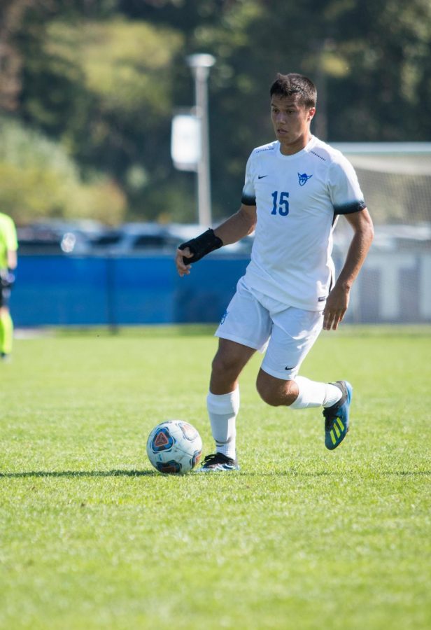 Wesley McNeese (20) controls the ball against St. Scholastica 