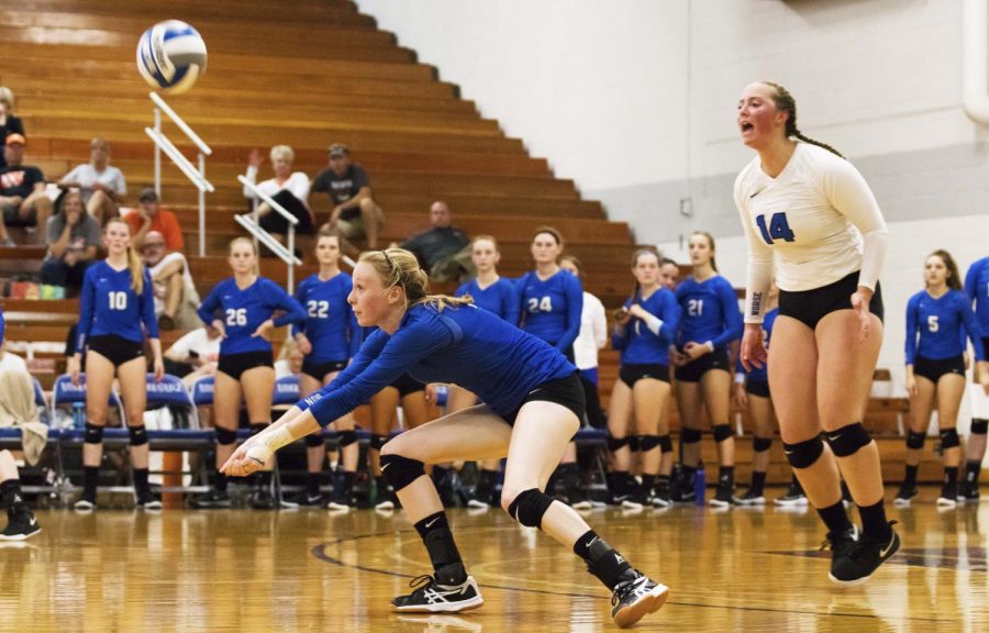 Paige Yontz (20) bumps the ball to a teammate while her teammates look on.