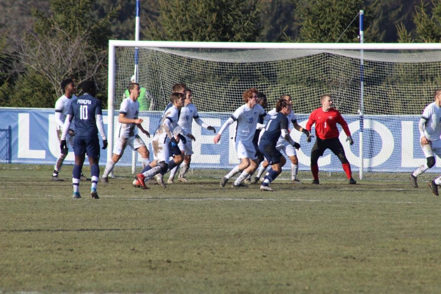 Goalie Carson Davenport ('21) and several team members prepare for a corner kick.