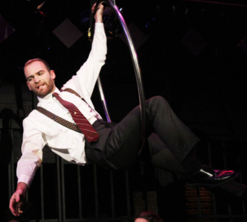 Trevor Haren (21) swings across the stage as he plays Billy Flynn.