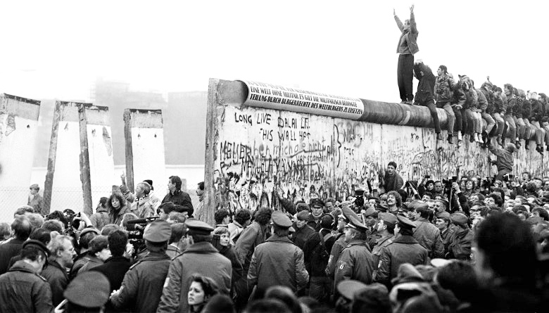 A crowd gathered around part of the Berlin Wall in 1989.