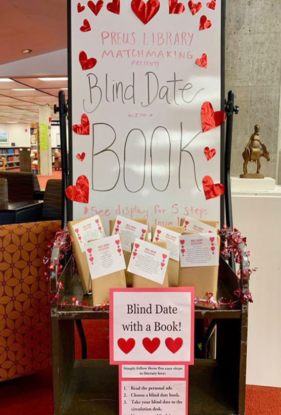 Students entering Preus Library are greeted by a cart filled with "anonymous book dates."