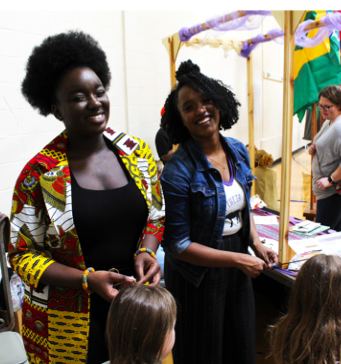 Members of BTQ provide hair-braiding services for attendees.