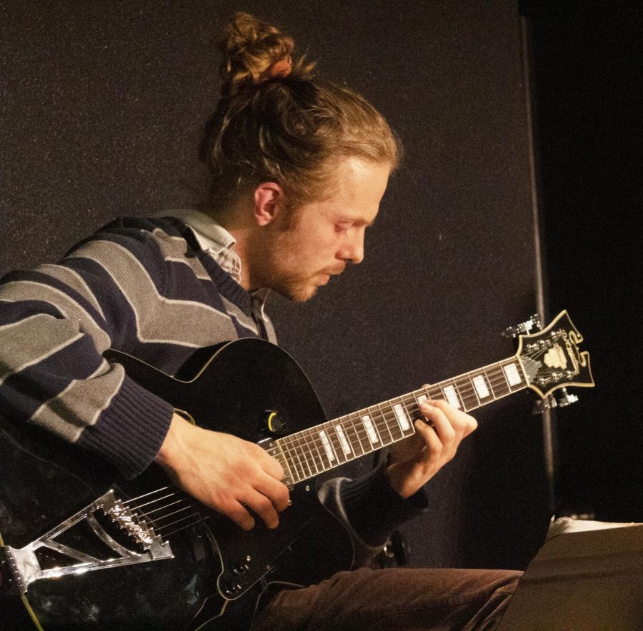 Free Time guitarist Troy Downey tunes his guitar before the show. 