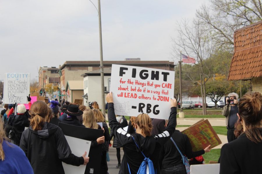 Protesters carry signs to support various causes they are passionate about.