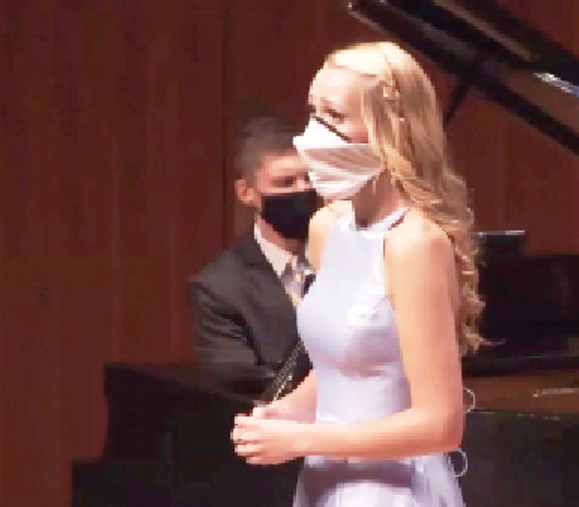 Pictured: Evelyn Galstad (‘20) in front, Dr. Nicholas Shaneyfelt accompanying on piano.  Image was screen-captured from the event’s livestream.                                                                                             											                                   Lelani Himegarner (‘23) I Chips	