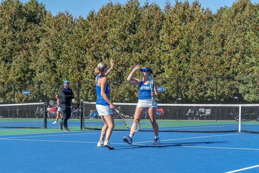 Devon Bourget (‘21), left, and Shelby Cook (‘22), right, celebrate winning a point in their doubles match during a meet against Central College on October 4, 2020. 