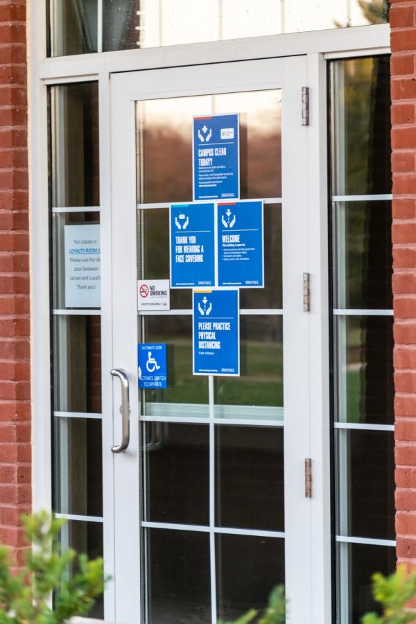 Luther College COVID-19 policies and procedures placed on building entrance. 