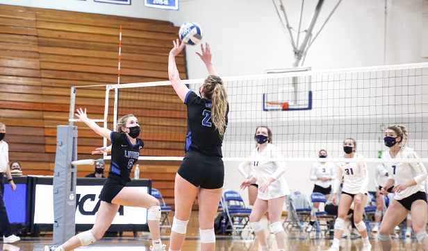 Callahan (‘21), right, sets middle blocker Rachael Luebbe (‘22), left, during a game against Loras on March 3, 2021.