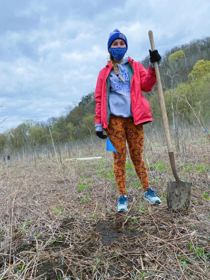 Ava Shively (24) plants a tree at the event. 
