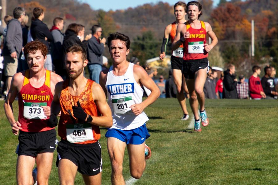  Ian Kelly (‘23, center) became the 23rd cross country runner in Luther history to earn All-Conference honors three times via his 10th place finish in the American Rivers Conference Championships. (Photo courtesy of Maya Warren and Luther College Photo Bureau)
