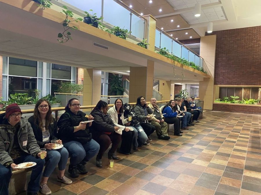 Special Olympic athletes and volunteers eat pizza outside of the Valders Lecture Hall during a meet and greet on November 15. Photo courtesy of Lydia Marti.