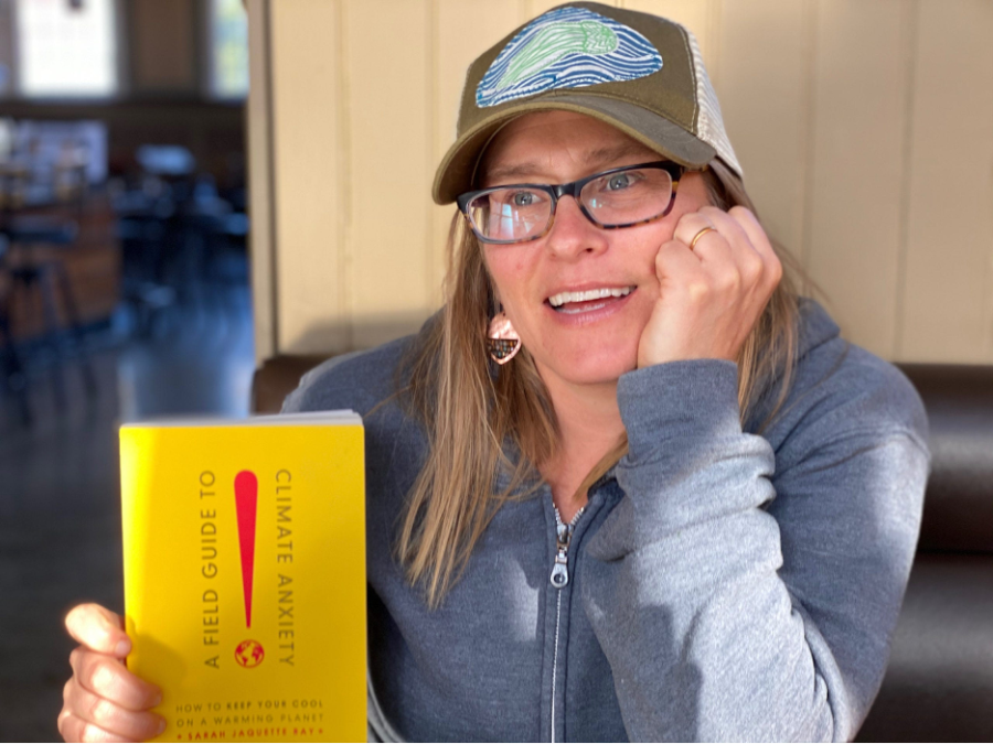 Author Sarah Jaquette Ray poses with a copy of  her book, “A Field Guide to Climate Anxiety”, the focus of a recent Center for Ethics and Public Engagement book group. Photo courtesy of Gen Dread.