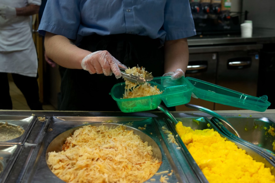 A Luther student Caf worker serves breakfast in 2020. Photo courtesy of Luther College Photo Bureau.