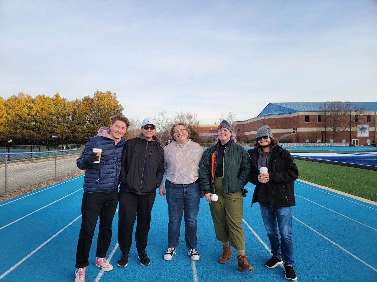 Nick Rogness (‘23), Neohemiah TwoBears (‘24), Max Koeller (‘24), Ingrid Gustafson (‘24), and Ian Gonzales (‘24) walk the track at Carlson Stadium on Friday morning.