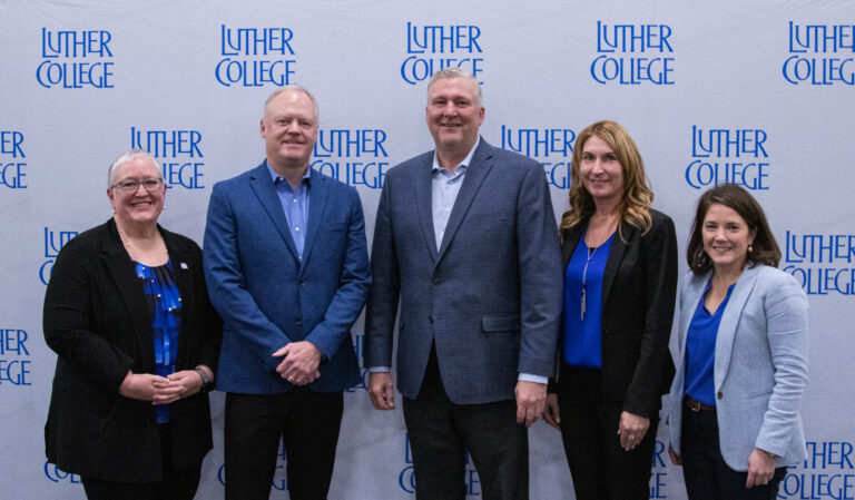 Luther College President Jenifer K. Ward, Mike Gerdin (92), former Mens Basketball coach Jeff Olinger (85), Director of Intercollegiate Athletics Renae Hartl and Vice President for Development Mary Duvall pose for a celebratory photo at the $10 million gift announcement on November 27. Photo courtesy of Luther Media Relations.