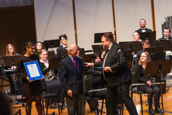 Gene Anderson (‘63) is presented the 2023 Dr. Carlo A. Sperati Award by Assistant Professor of Music and Director of Bands Dr. Cory Near (right) and Hannah Saucedo (‘24, left).
Photo courtesy of Armando Jenkins-Vazquez ('21)/Luther College Photo Bureau.