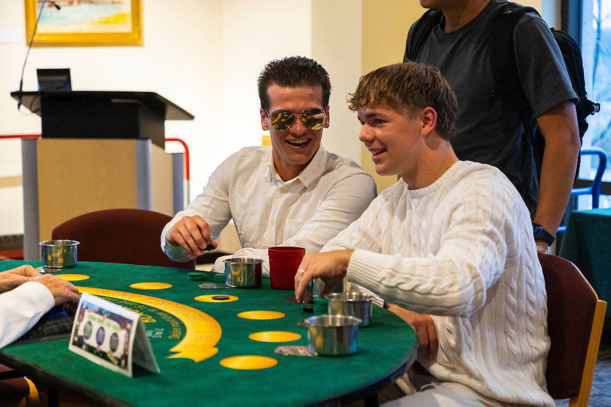 Jake Althaus (‘27, left) and Ramon Wenker (‘27, right) go all in on a game of blackjack at SAC’s Casino Night on April 27. Photo courtesy of Duy Nguyen (25)/Luther College Photo Bureau.