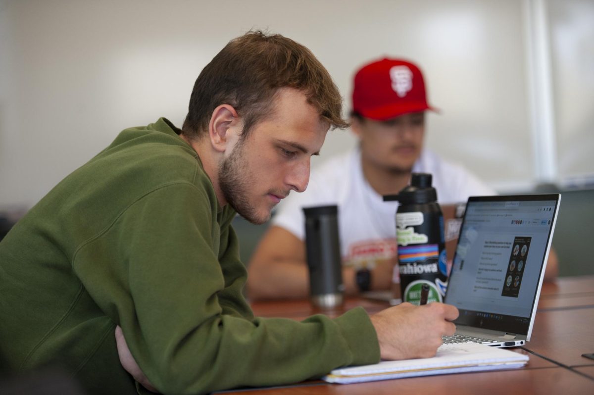 A rare photo of Peter Heryla (24) actually doing his classwork instead of writing and editing CHIPS stories (if any professors read this hes kidding...sort of.) Photo courtesy of Kent Kriegshauser/Luther College Photo Bureau.