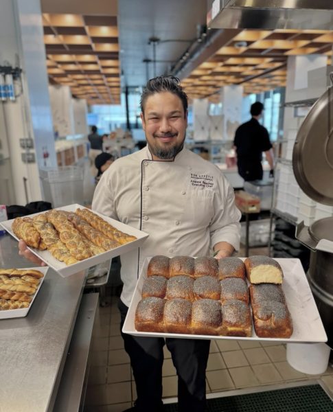 Bon Appétit Management Company Executive Chef Andrew Baechler posing with Ghibli-inspired menu items at California College of the Arts. Photo courtesy of @bonappetitcca on Instagram.