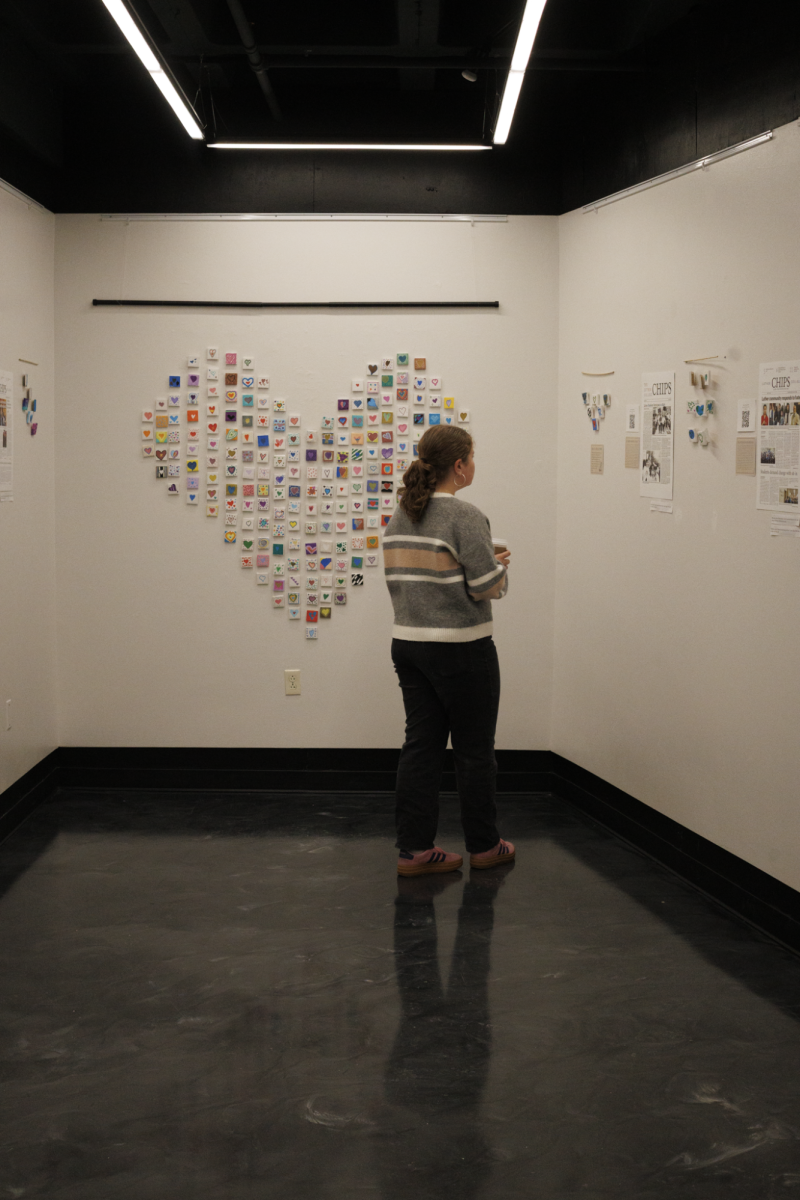 Audrey Zielstra ('26) walks through the gallery during the exhibit's open house. 